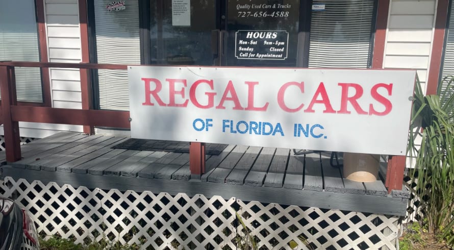 The Regal Cars of Florida, Inc. sign outside the dealership on 49th St. N. in Clearwater, FL
